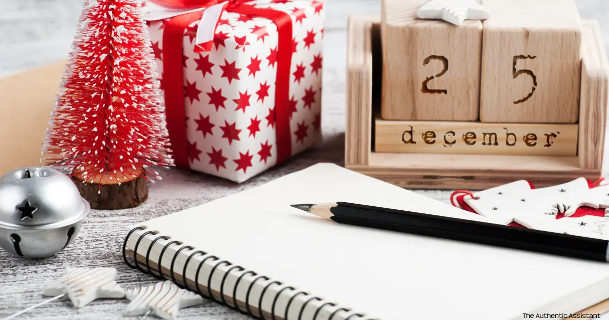 A photo of wrapped christmas present with a wooden calendar marked 25th December. A notepad and pencil ready for the list.